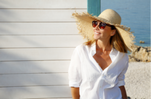 Close-up portrait of smiling female by the sea.