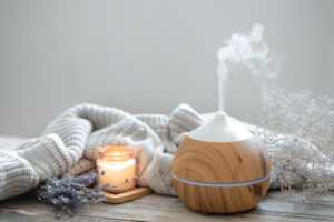 Aroma composition with a modern aroma oil diffuser on a wooden surface with a knitted element