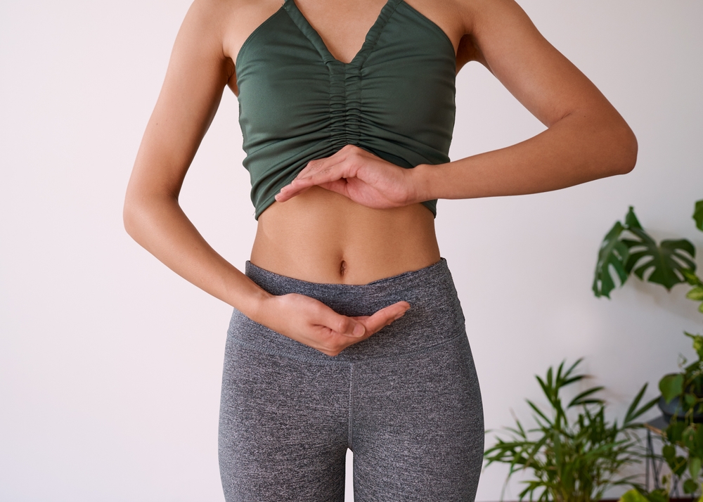 Cropped,Shot,Of,A,Young,Multi ethnic,Woman's,Stomach,Cupped,By