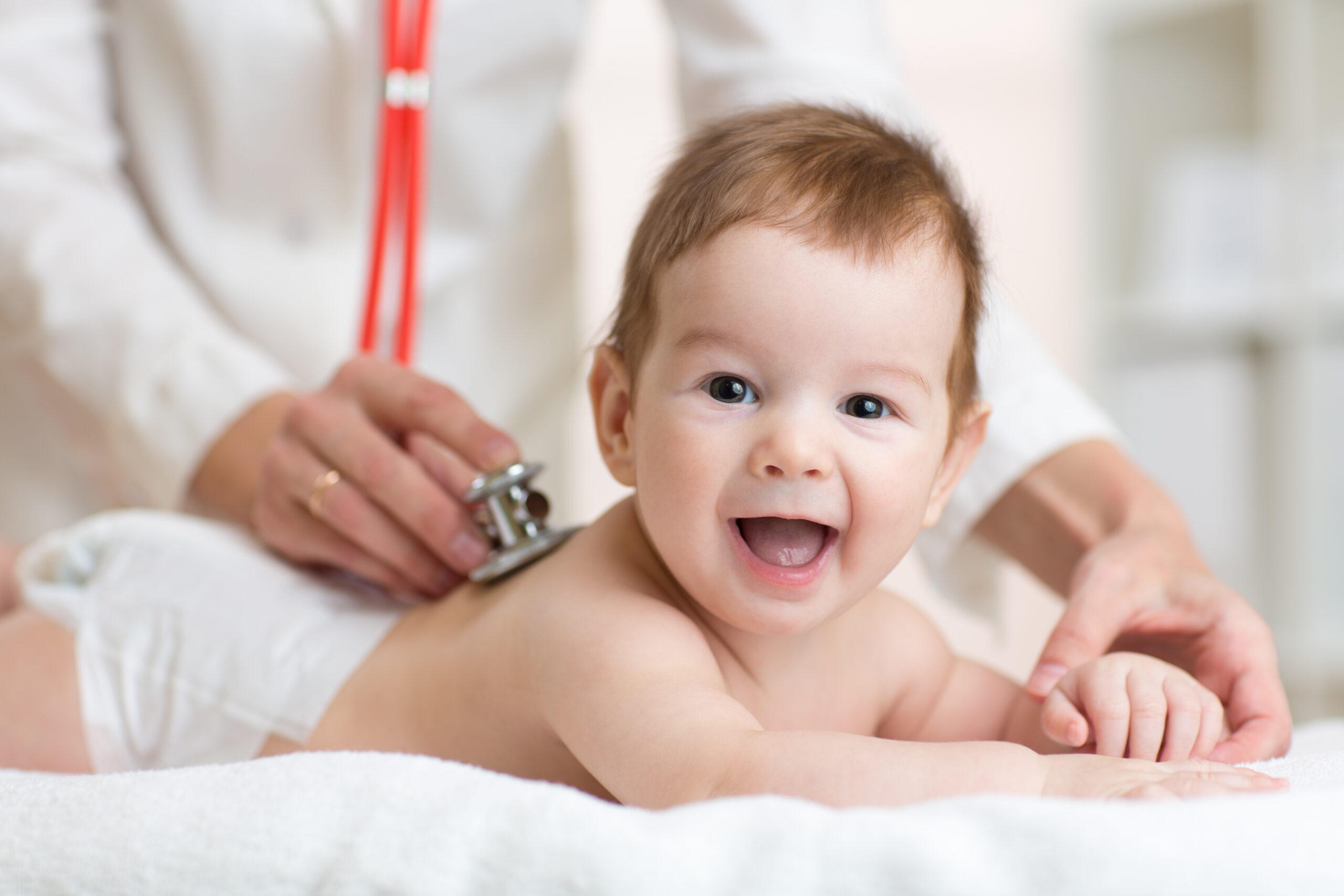 A pediatric surgeon monitoring a baby’s heartbeat
