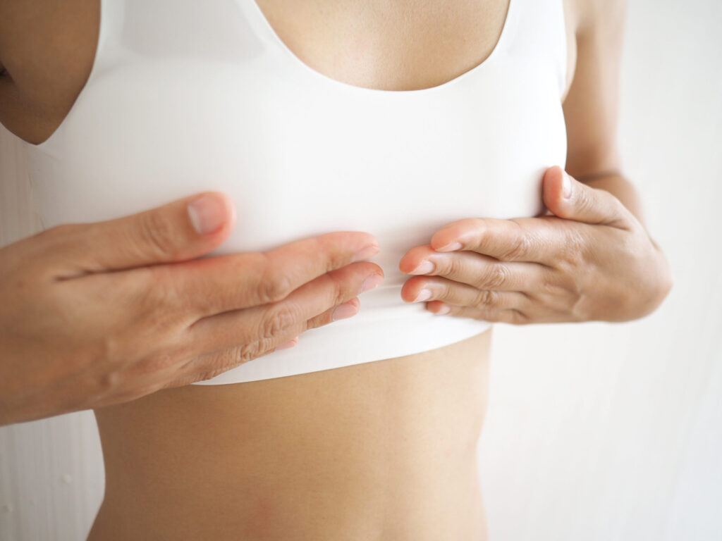 Close up of person's chest considering transgender breast augmentation in Austin, TX