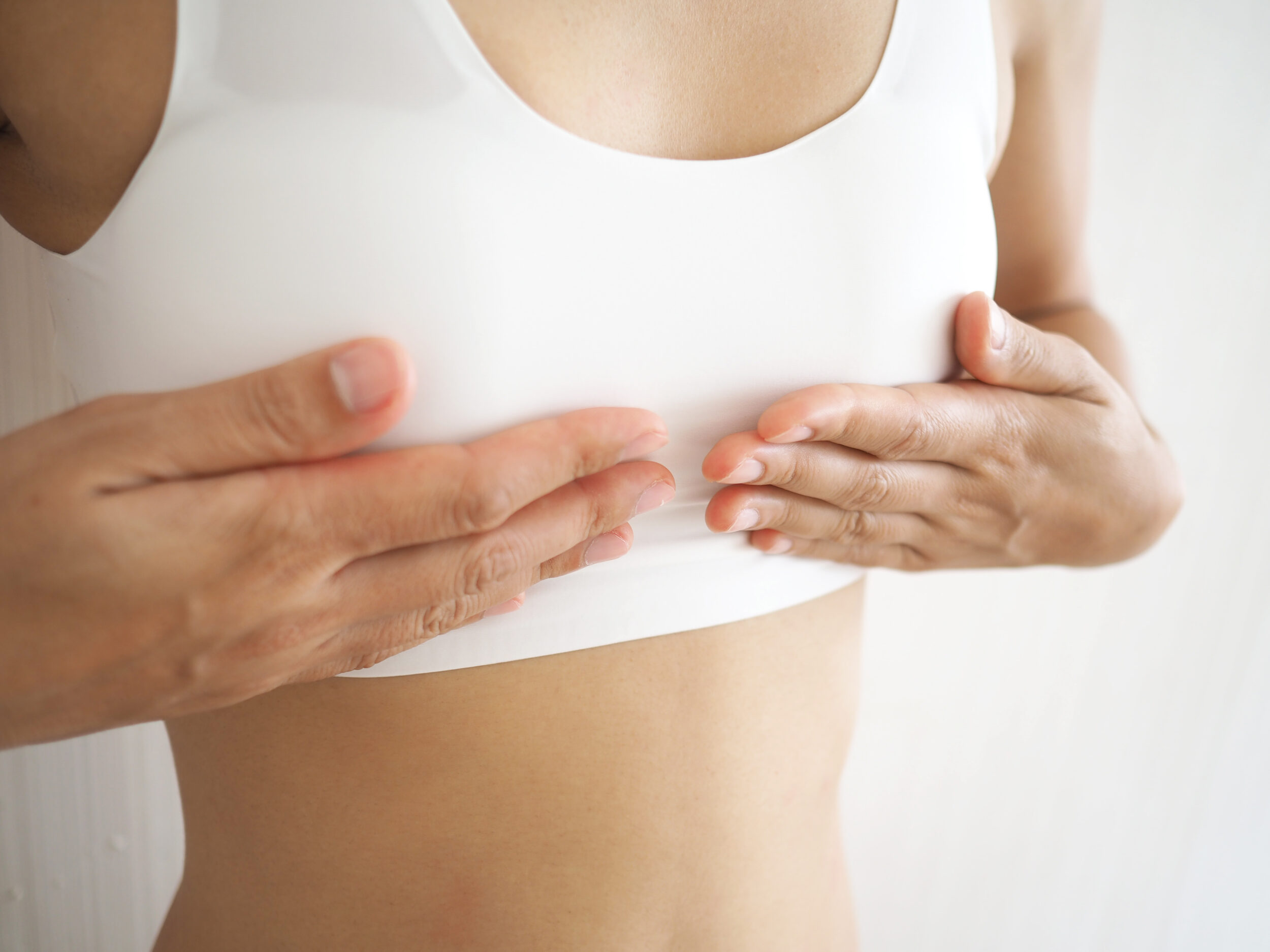 Close up of person's chest considering transgender breast augmentation in Austin, TX