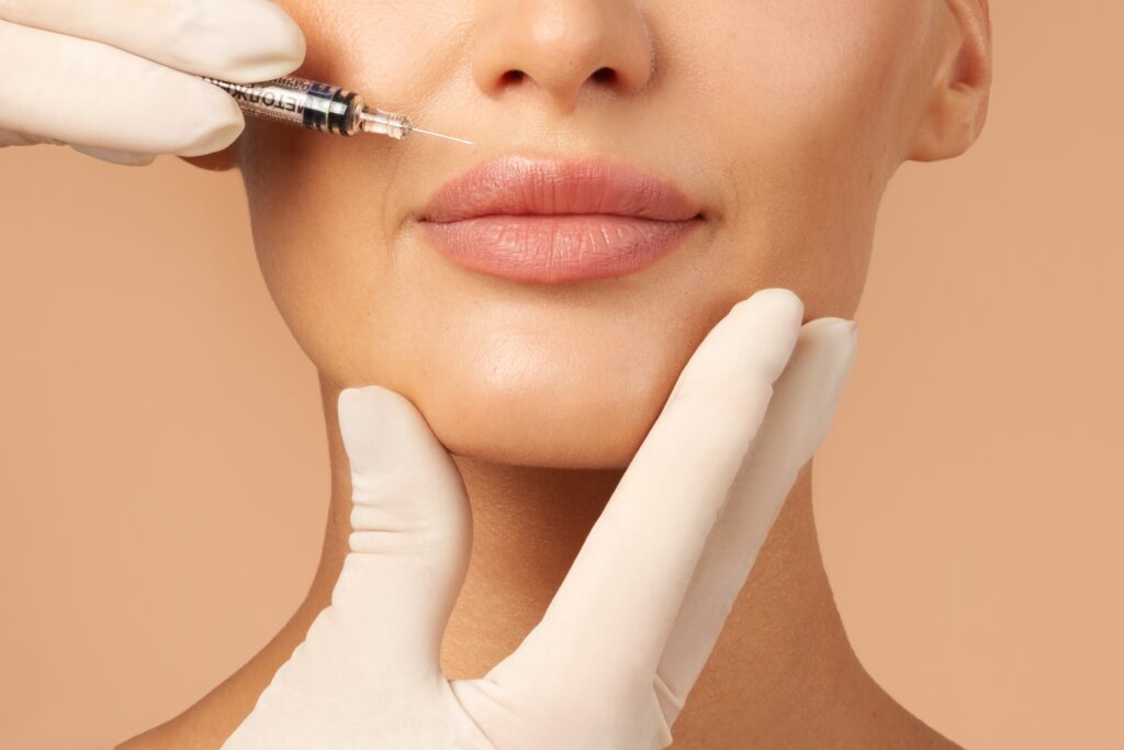 Woman's lips getting lip filler injections in Austin, TX