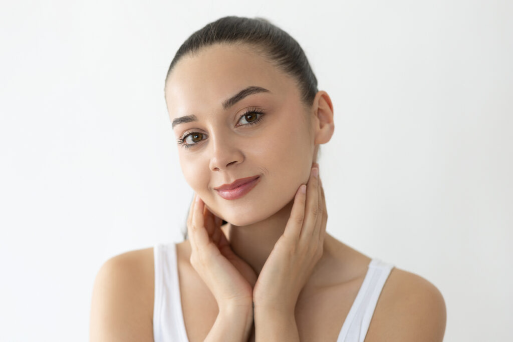 Woman smiling with fresh skin from facial fat grafting in Austin, TX
